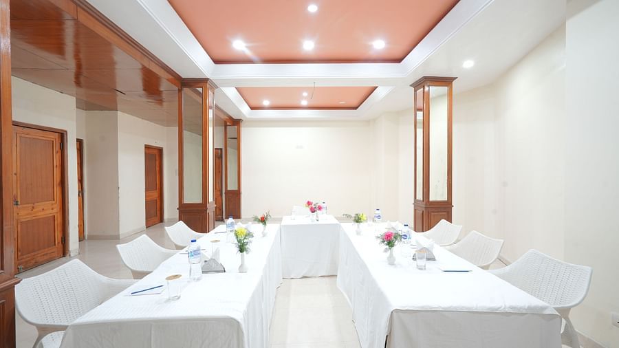 Conference hall with chairs and tables neatly arranged at DLS Hotels The Rock Castle.